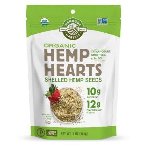 Organic hemp hearts shelled hemp seeds with strawberries on a spoon.