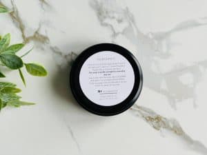 Healthy Roots Allantoin Face Soap in black jar on marble surface.