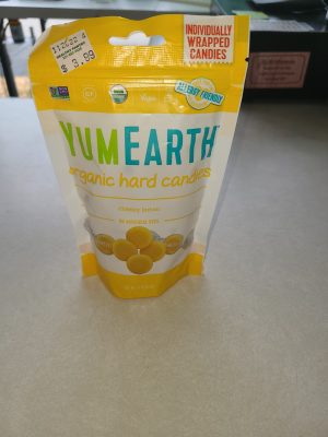 Yum Earth organic hard candies in yellow packaging with lemon flavor.
