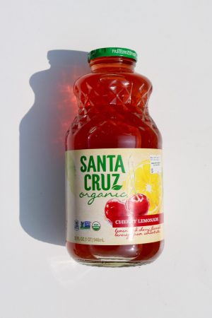 Organic Cherry Lemonade juice bottle with label and green cap.