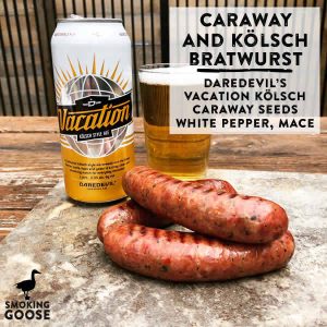 Caraway and Kölsch bratwurst with beer and can on wooden table.