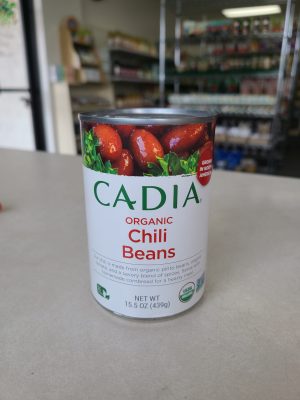 Cans of Cadia Organic Chili Beans on store shelf.