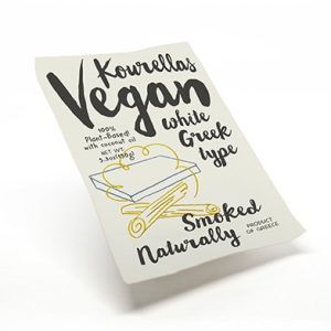 Vegan smoked cheese packaging with Greek style label and illustration.