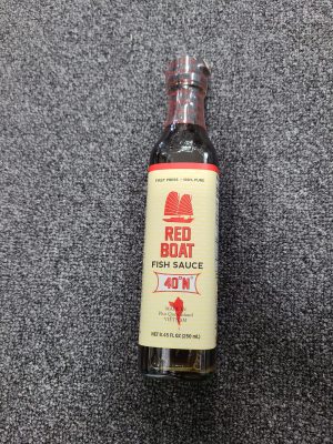 Red Boat Fish Sauce bottle on a textured surface, 40°N, 250ml.