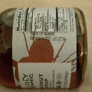 Unrefined coconut syrup in glass bottle with label, natural sweetener from Healthy Roots.