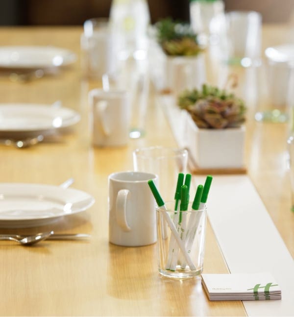 event table with mugs plates and pens