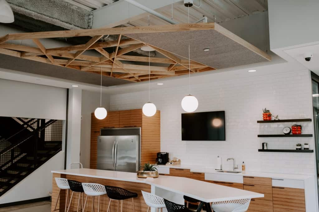 Contemporary kitchen with sleek white cabinets and wooden accents.