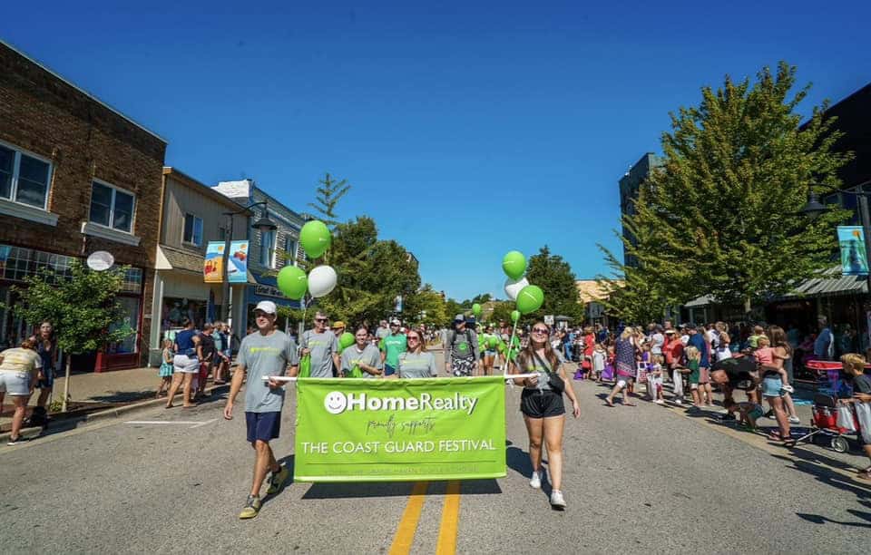 Colorful parade for HomeReality at the Michigan Coast Guard Festival with community participation an
