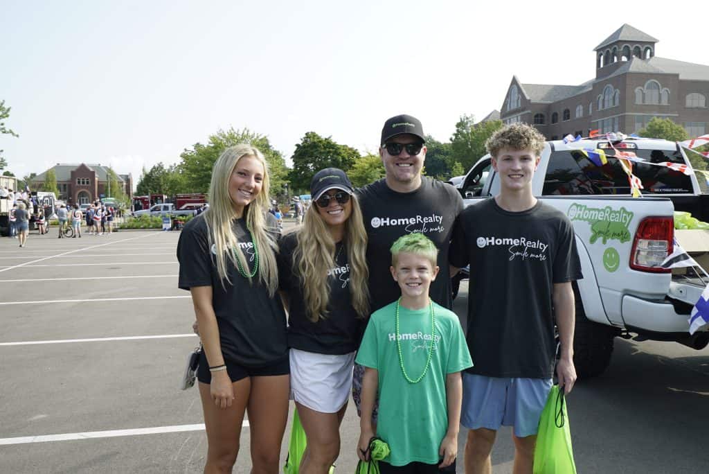 HomeRealty team at community event in Michigan parking lot.