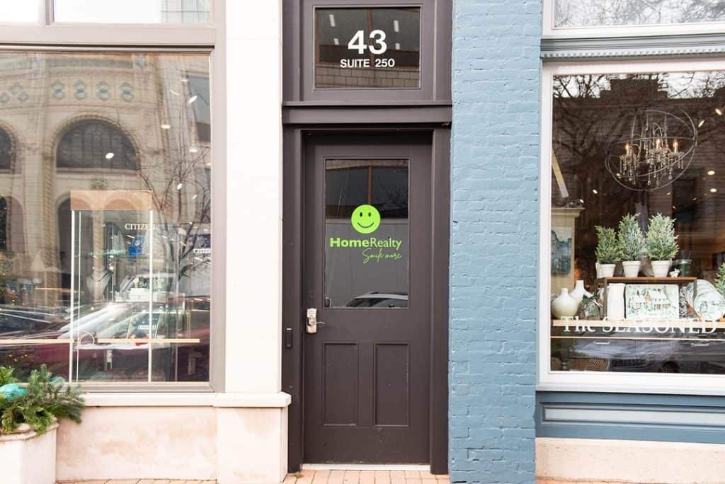 HomeRealty office door with logo and address at 43 Suite 250.