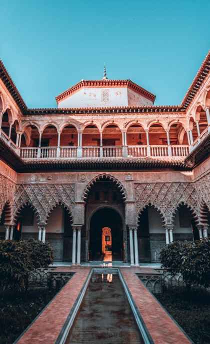 Stunning view of the intricate courtyard architecture at Alcázar of Seville in Spain.