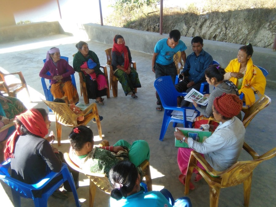 Training on water resource management and health and safety, led by a project worker, with many community members. 