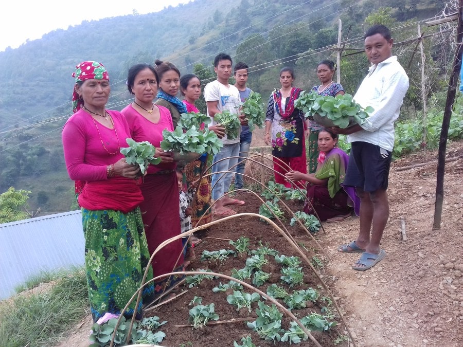 Community members in Jimi with their agricultural produce