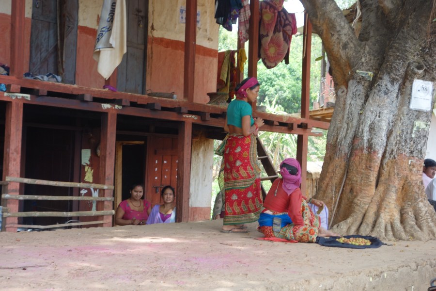 Women work in front of a building in Sanneghari