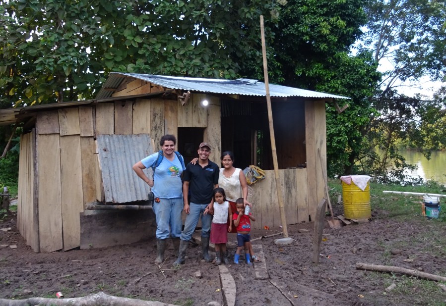 A family and the blueEnergy technicians with their newly installed solar energy system