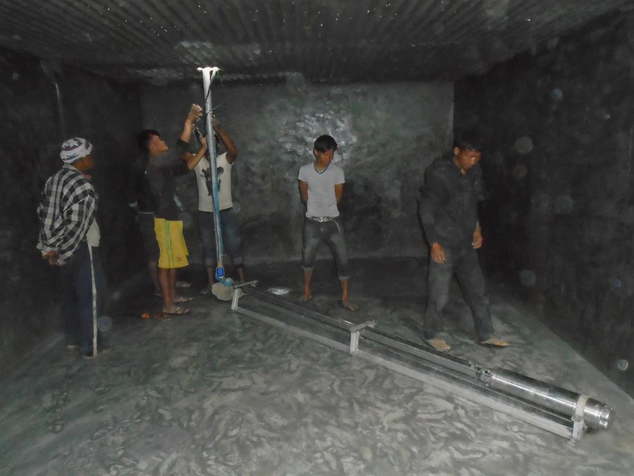 Five men work together in installing wiring for the solar-powered pump in Jugedhara.