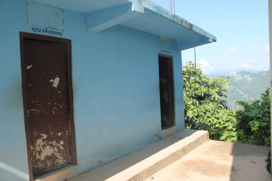 An outside view of the poorly maintained toilet building at the school.