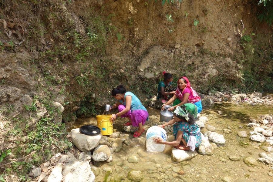 Women collect water for the community in Sanneghari