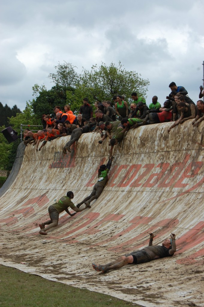Gethin helping a team member up the wall.