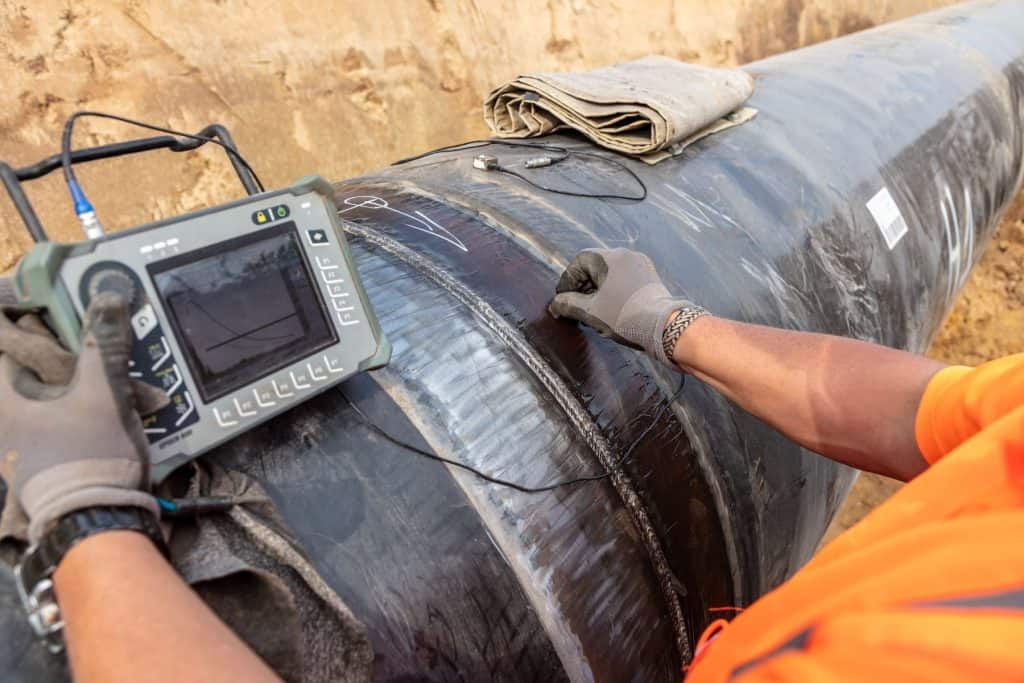 Ultrasonic pipeline inspection for detecting corrosion and defects.