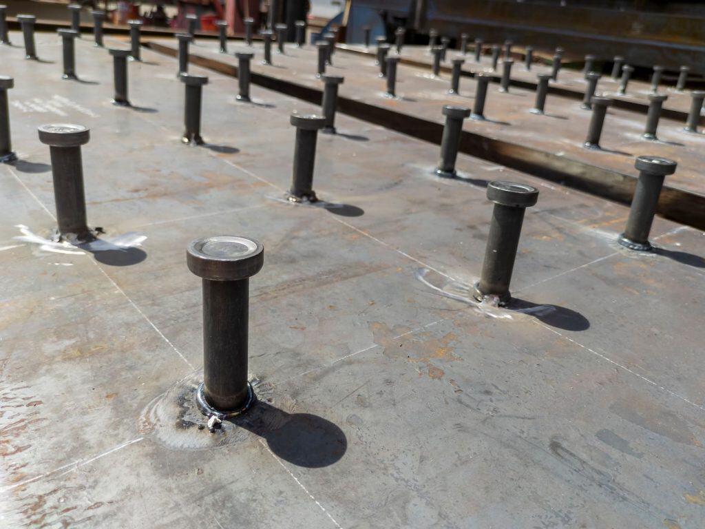 Steel bolts embedded in concrete for building stability and safety.