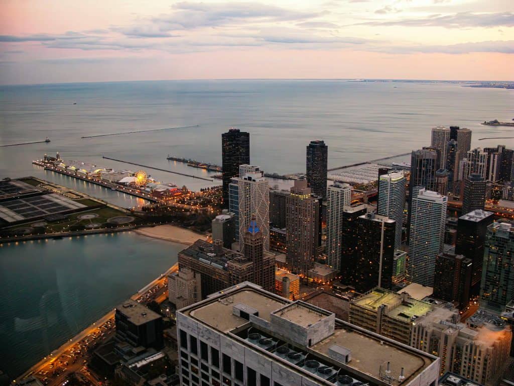 Aerial view of Chicago's cityscape with Lake Michigan in the background.