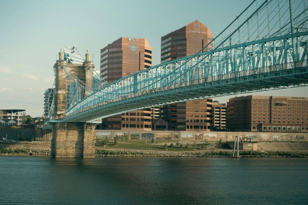 Bridge over the Ohio River in Cincinnati, Ohio, with city buildings in the background.