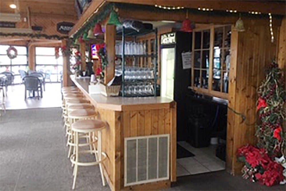 Cozy bar area at Leroy's Classic Bar & Grill with wooden decor and festive decorations.