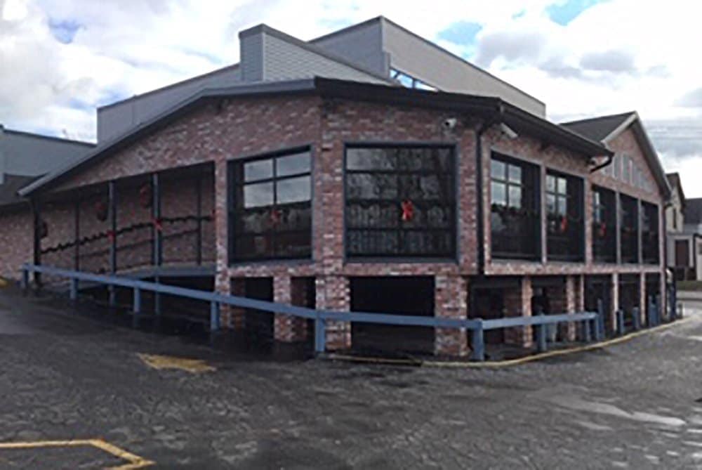 Exterior view of Leroy's Classic Bar & Grill with brick facade and large windows.