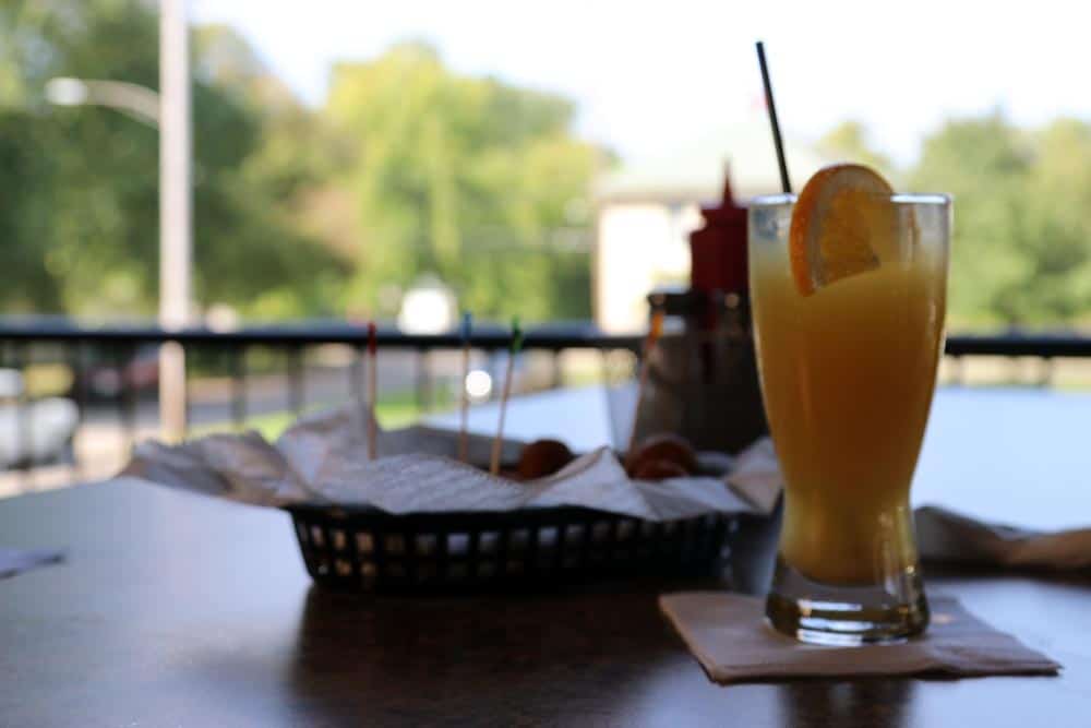 Refreshing orange cocktail with lemon slice at Leroy's Classic Bar & Grill.