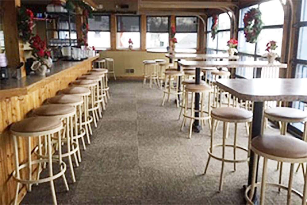 Interior view of Leroy's Classic Bar & Grill with high tables and bar stools.