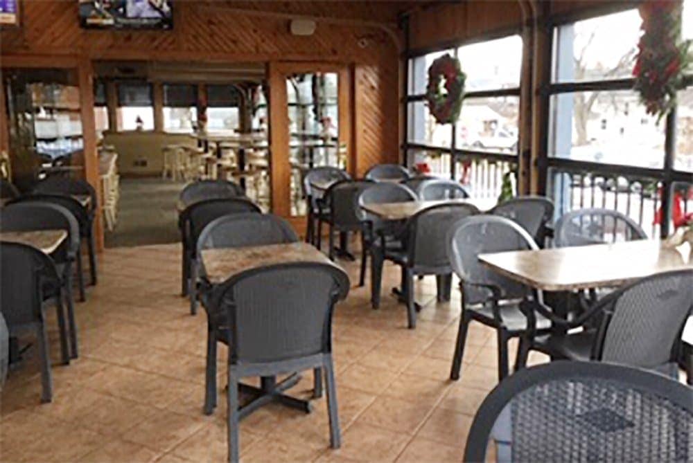 Indoor dining area at Leroy's Classic Bar & Grill with tables and chairs.