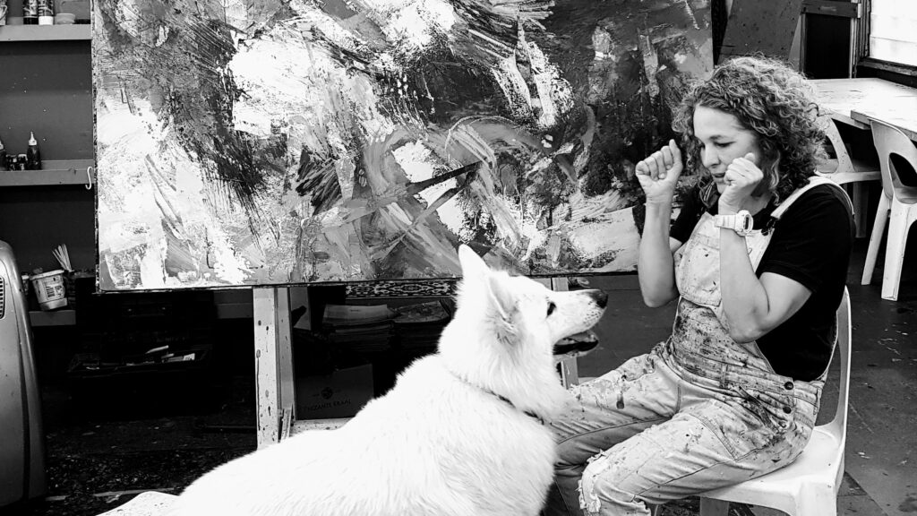 Artist painting abstract landscape in studio