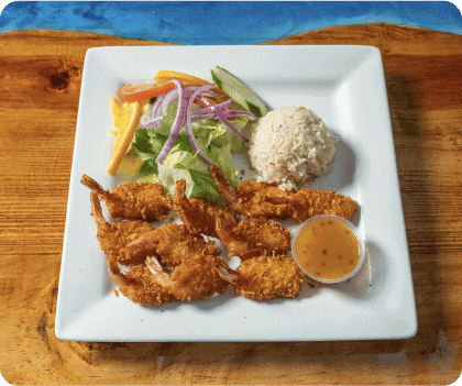 Crispy fried shrimp served with salad, rice ball, and dipping sauce on a white plate.