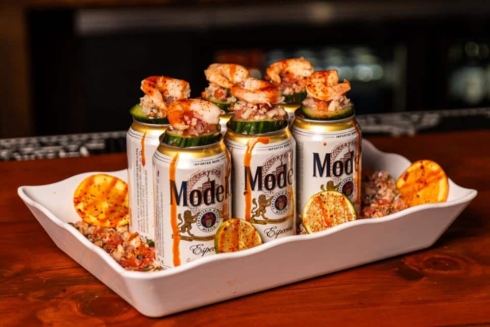 Canned shrimp seafood tacos with lime and seasoning on a white platter.