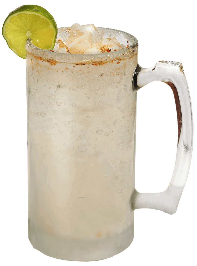 Refreshing margarita mangoneada with lime slice and ice in a glass mug.