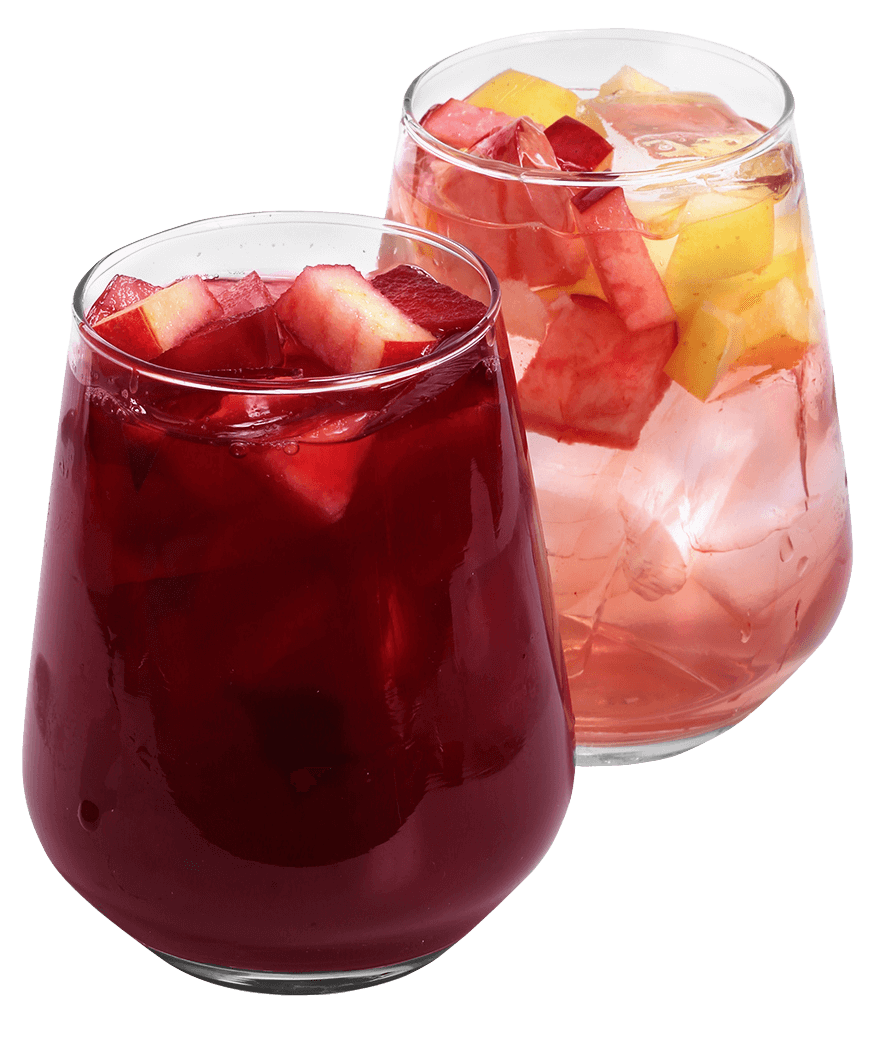 Two colorful mangonada drinks with watermelon and fruit chunks in glasses.