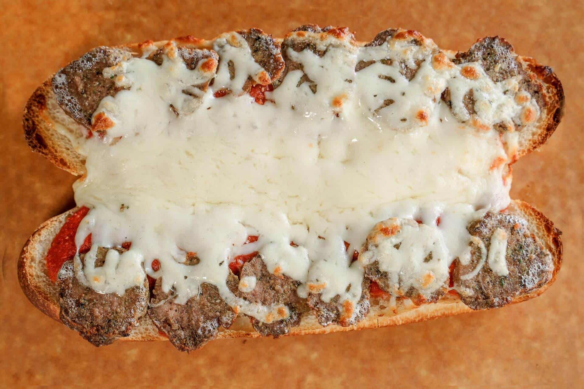 Sicilian pizza with cheese and toppings on a crust.