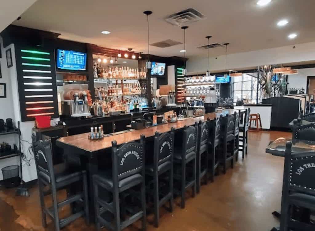 Bar counter with seating in a modern restaurant setting.