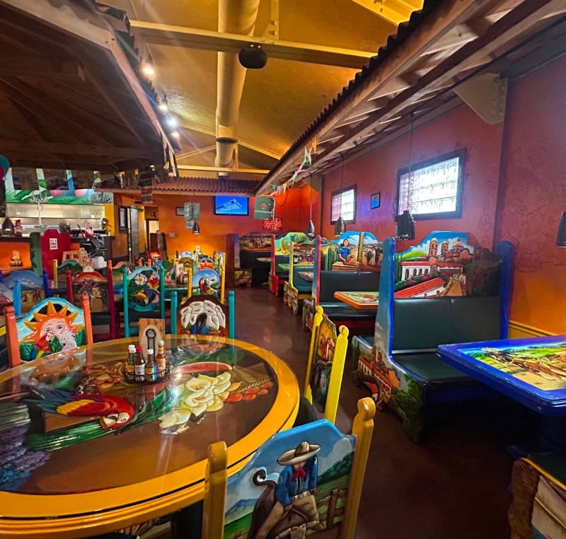 Vibrant Mexican restaurant interior with colorful decor and lively atmosphere.