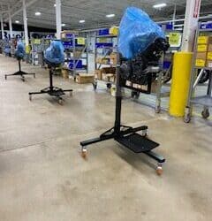 Metal fabrication machinery in a factory setting with blue protective covers.