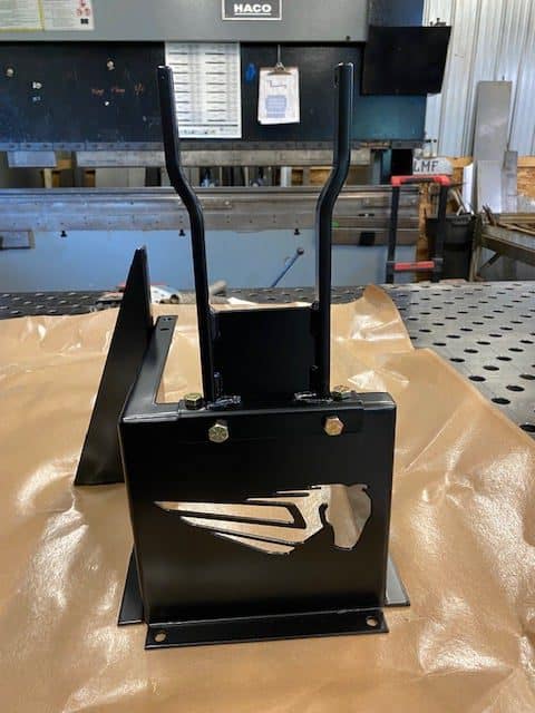 Black metal bracket with handles and cutout design for industrial use.