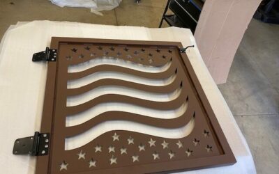 Decorative metal sign featuring waves and stars, brown finish, for wall decor.