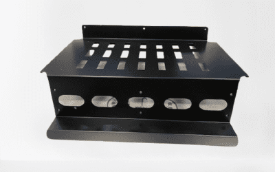 Black metal fabrication rack with multiple slots and cutouts.