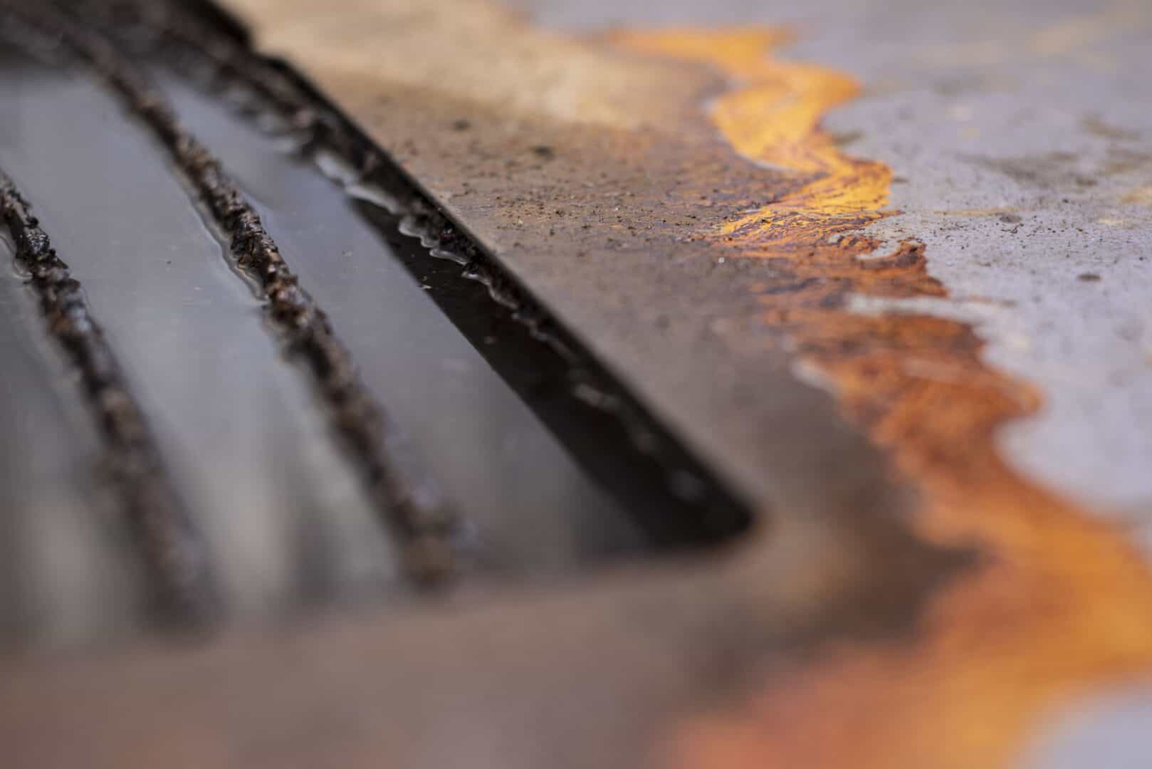 Close-up of metal cutting with sparks and molten metal.