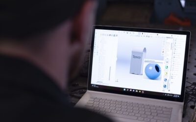 Person viewing 3D CAD design of metal parts on laptop screen.