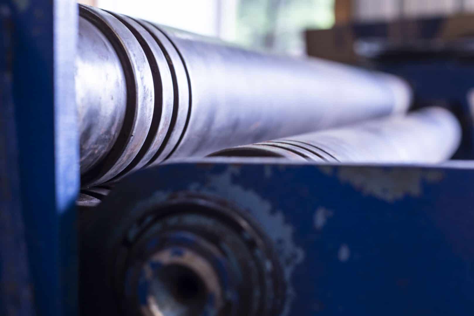 Industrial metal rollers at Lynch's Metal Fab workshop.