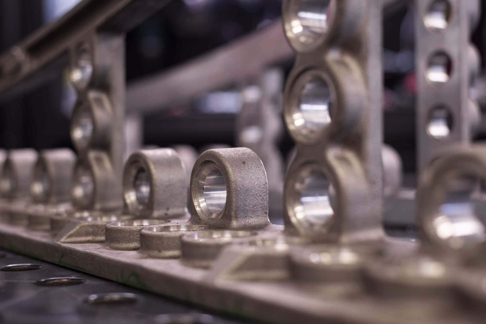 Close-up of machined metal parts and brackets at Lynch's Metal Fab.
