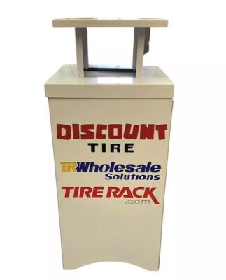 Tire rack with Discount Tire, TR Wholesale Solutions, and Tire Rack logos.