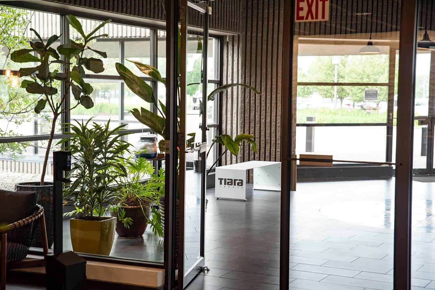Modern industrial interior with plants and glass doors at Lynch's Metal Fab.